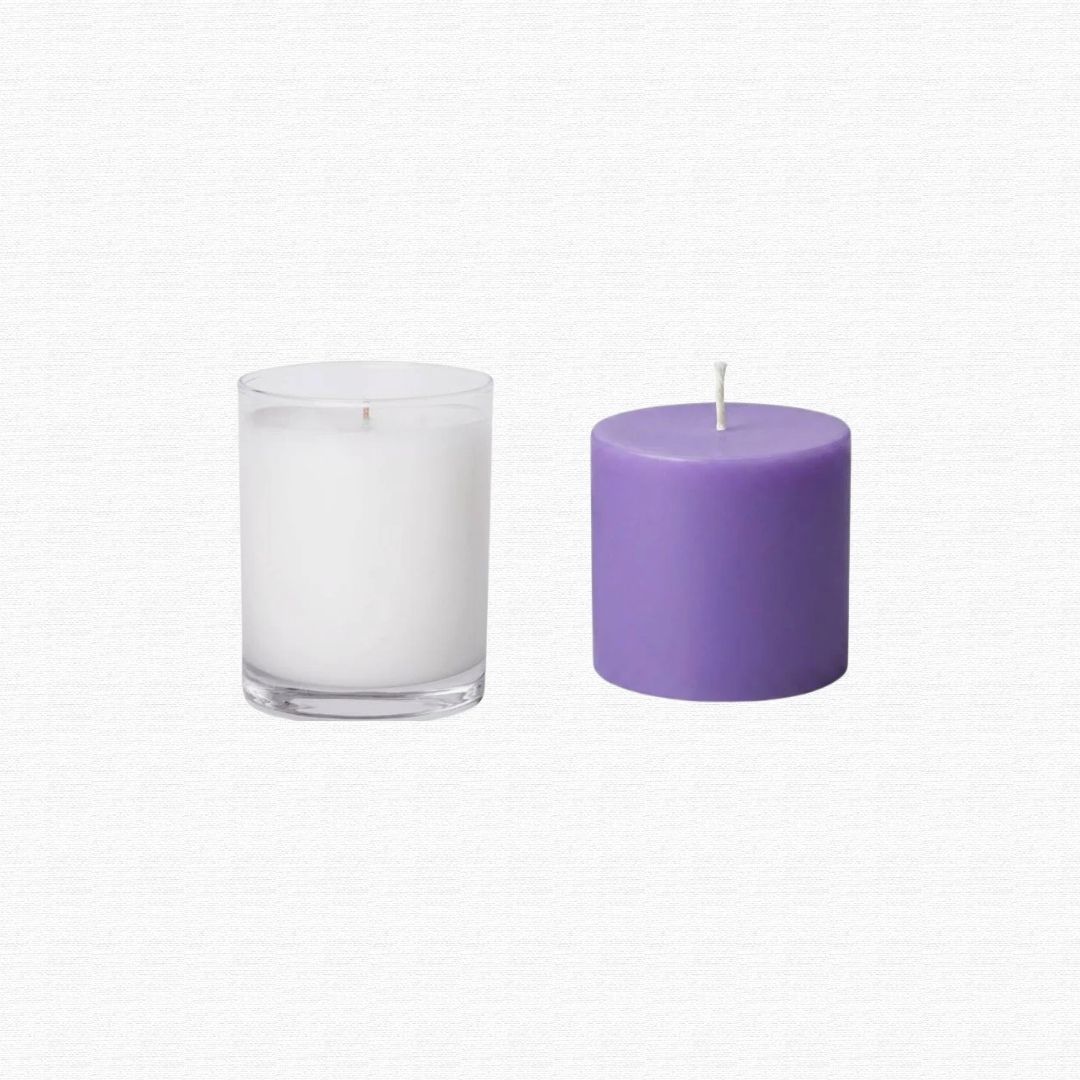 An empty glass jar candle holder with leftover wax.