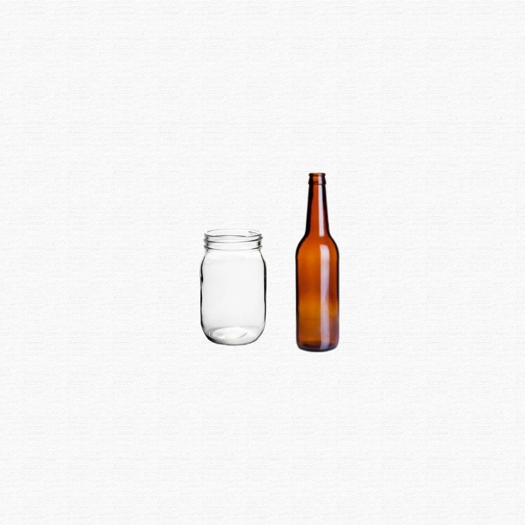 Clear, green, and amber glass jars and bottles stacked together