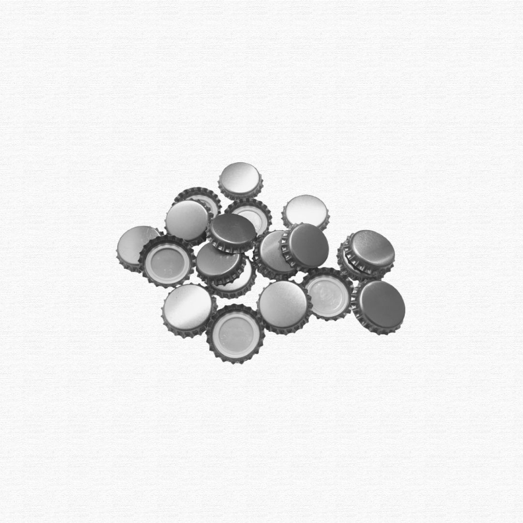 A collection of crimped metal crown caps from glass beverage bottles