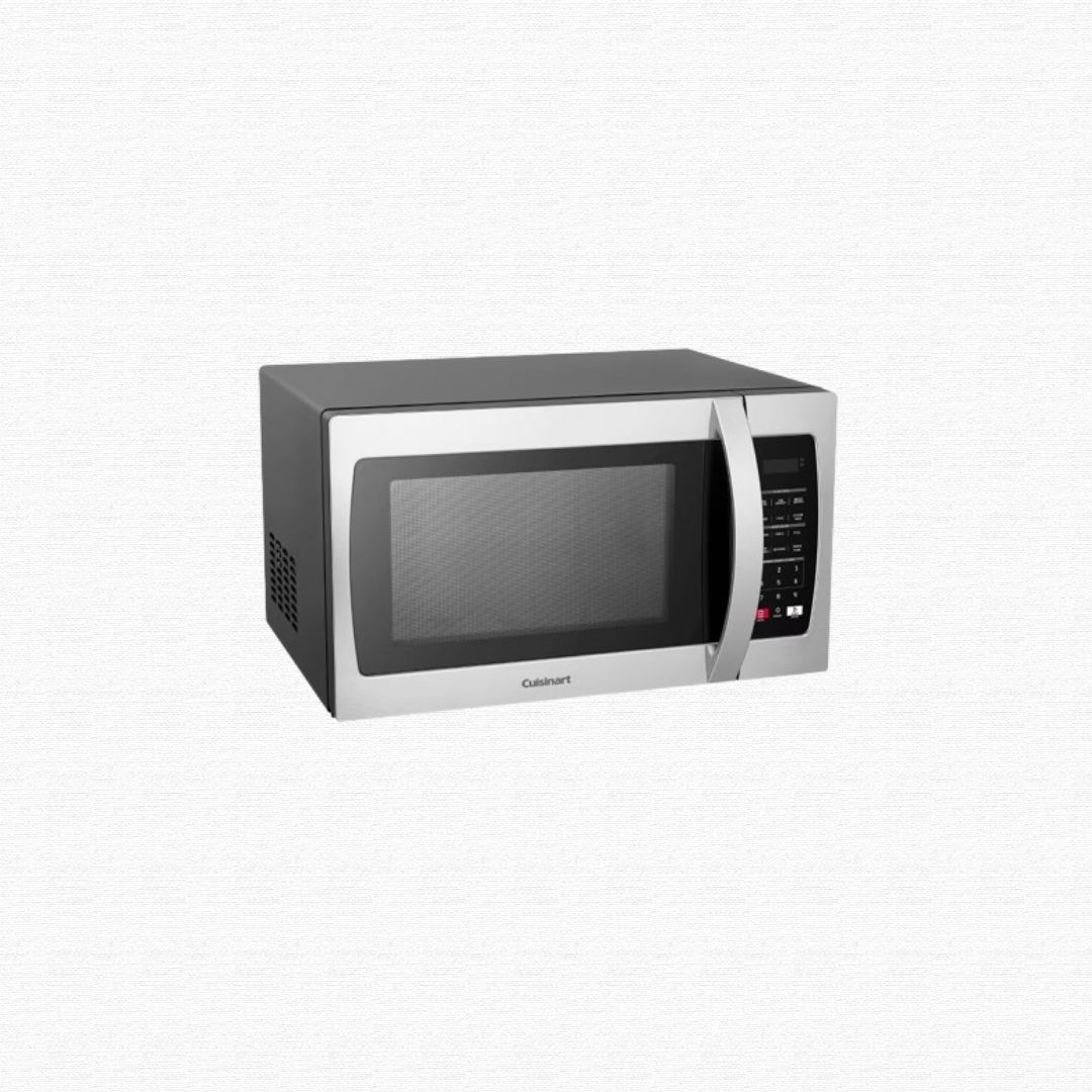 An old countertop microwave unit being prepped for metal reclamation.