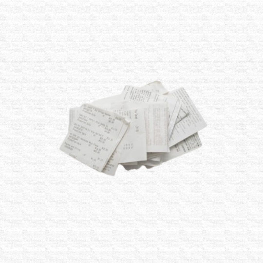 A crumpled handful of printed paper store receipts